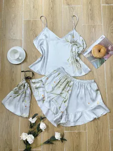 Elegant silver silk-like pajama set with floral print including camisole and shorts