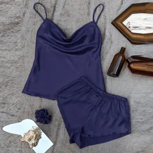 Elegant navy blue satin pajama set featuring a camisole top and matching shorts