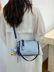 Fashionable denim blue crossbody bag for women featuring sparkling studs and a cute puppy charm