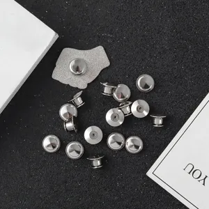 Detailed macro view of replacement silver metal pin backs and clutch badge clasps