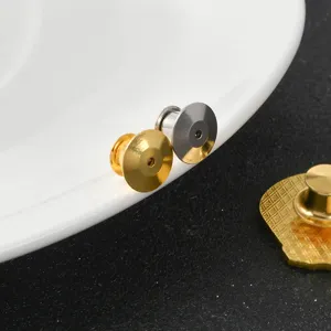 Close-up of metallic butterfly clutch pin backs in gold and silver finishes