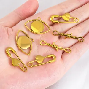 Gold-plated stainless steel charms including heart pins and evil eyes on a palm.