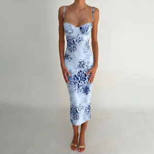 Close-up detail of blue and white printed bodycon slip dress, spaghetti strap neckline.