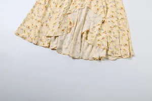 Discover this exquisite yellow floral dress detail featuring delicate ruffle hems and soft fabric.
