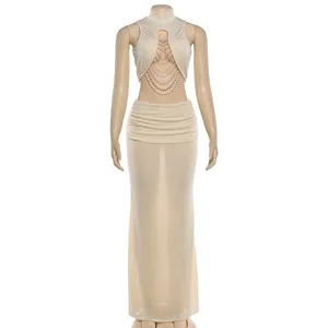 Detailed view of beige sleeveless pearl-chained crop top and ruched low-waist skirt set.