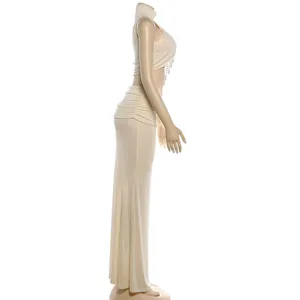 Beige two piece outfit detail, sleeveless mock neck crop top with pearl chain and maxi skirt.