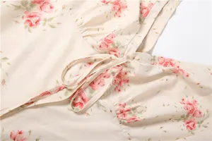 Close-up detail of women floral print dress with delicate tie drawstring and soft fabric.
