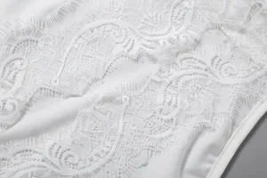 Close-up detail of women's sexy irregular spliced white lace sleeveless tank top trim.
