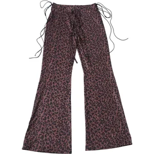 Detailed view of women leopard print low waist flare pants with stylish side drawstrings.