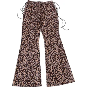 Detail view of trendy leopard print low-waist flare pants featuring chic side drawstring cords.