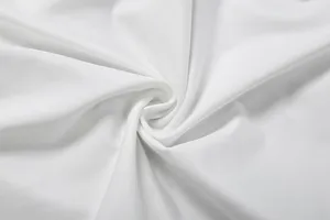 Close-up view of soft white fabric texture showing fine weave and elegant drape detail.