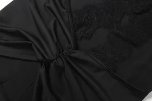 Black lace sleeveless top fabric detail showing fine texture and elegant floral pattern trim.