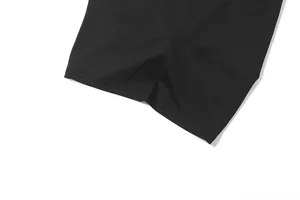 Detailed view of the black tank top fabric, showing fine stitching and smooth black texture.