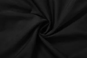 Close-up detail of smooth black fabric, showing fine texture, soft drape and delicate woven pattern.