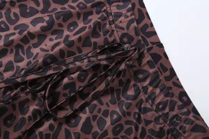 Leopard print flare pants detail shot featuring stylish drawstring and ruched design for women.