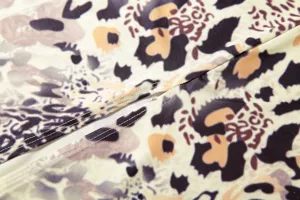 Sexy leopard print dress fabric detail showing fine stitching and soft textile texture.