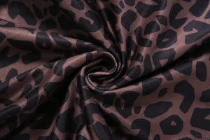 Detailed shot of trendy leopard print fabric for women fashion stretch flare trousers.