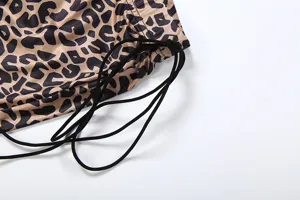 Leopard print women trousers detail view showing trendy pattern and black drawstring cords.