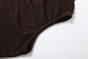 Brown knit top detail shot showing fine fabric texture, ribbed edge, and clean craftsmanship.