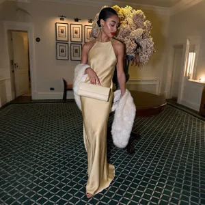 Stunning gold halter satin long dress featuring a backless design for summer evenings.