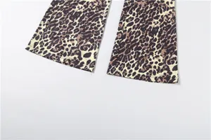Detail view of women leopard print slim flare pants hem showing stylish pattern texture.