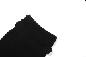 Black solid color fabric detail shot, soft texture, minimalist design style for women's clothing