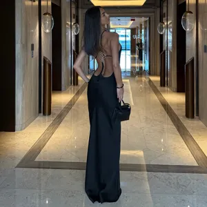 Discover this sexy black backless maxi dress featuring a chic halter design and slim bodycon fit.