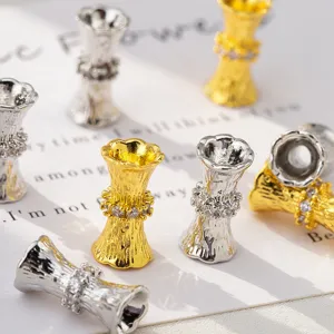 Waist-shaped textured spacer beads with rhinestone inlay in gold and silver finishes