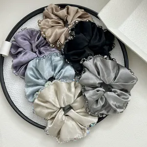 Elegant satin hair scrunchies with crystal bead trim in various metallic colors for women.