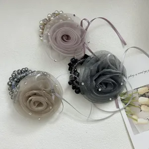 Détail de chouchous élégants avec roses en résille, perles et cristaux décoratifs brillants