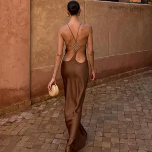 Detailed back view of a sleek brown satin maxi dress featuring a stunning rhinestone back strap design.