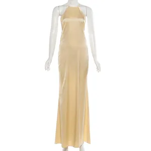 Statin halter maxi dress detail, elegant champagne backless long gown close-up view.