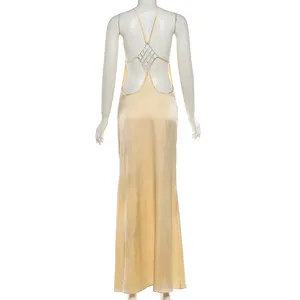 Detail view of a sexy backless solid maxi dress featuring a chic rhinestone back design.