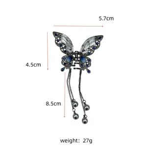 Detailed measurement view of this butterfly hair claw clip featuring elegant tassels.