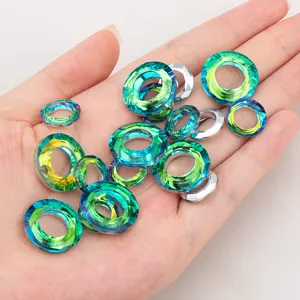 Vibrant faceted teal glass ring beads held in hand for DIY jewelry making crafts
