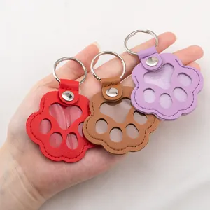 Leather paw-shaped pet hair collection charms in red, brown, and purple finishes