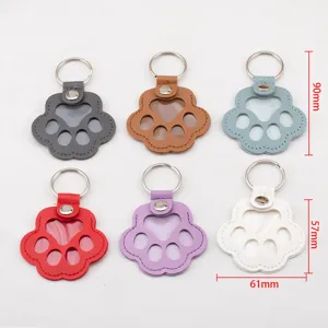 Set of six leather paw-shaped keychains for pet fur collection and memorial pendants