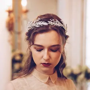 Detailed close-up shot of an elegant silver bridal hair chain with crystal leaf motifs