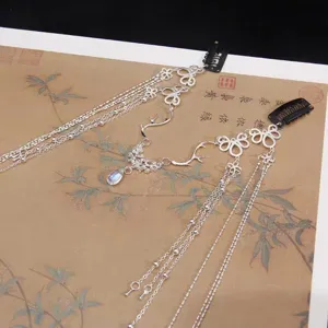 Close-up of silver-toned forehead chain with crystal drop for bridal or Hanfu wear