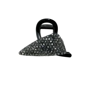 Detailed view of a black hair claw clip with shimmering grey crystal embellishments