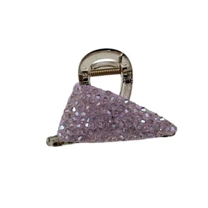 Macro detail view of a purple crystal encrusted triangle hair claw clip with elegant sparkle