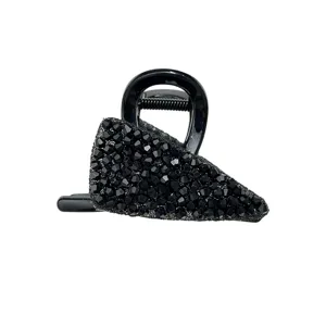 Detail view of a black crystal-encrusted hair claw clip for elegant styling