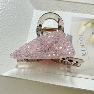 Detailed side view of a premium pink crystal-encrusted hair claw clip with sparkling rhinestones