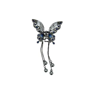 Elegant metal butterfly hair claw clip with blue crystals and long dangling tassels