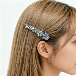 Detailed side view of a blue crystal flower hair clip worn on elegant long hair