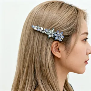 Elegant side view of blue crystal flower hair clip accessorizing a model's hair.