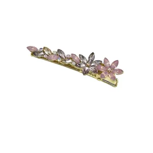Elegant gold-tone hair clip featuring pink and lavender crystal flowers with sparkling zircons