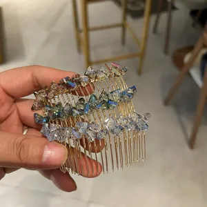 Detailed macro view of a sparkling colorful crystal hair comb with gold-tone metal teeth
