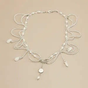 Detail view of handmade pearl and crystal forehead chain with elegant teardrop pendants.