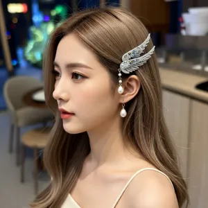 Detailed view of angel wing hair clip with crystal rhinestones and pearl tassels
